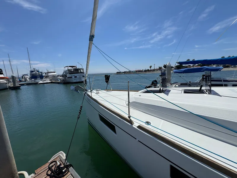Slide: The Image of 2021 Beneteau Oceanis 35.1 sailboat docked in a sunny marina. - 4