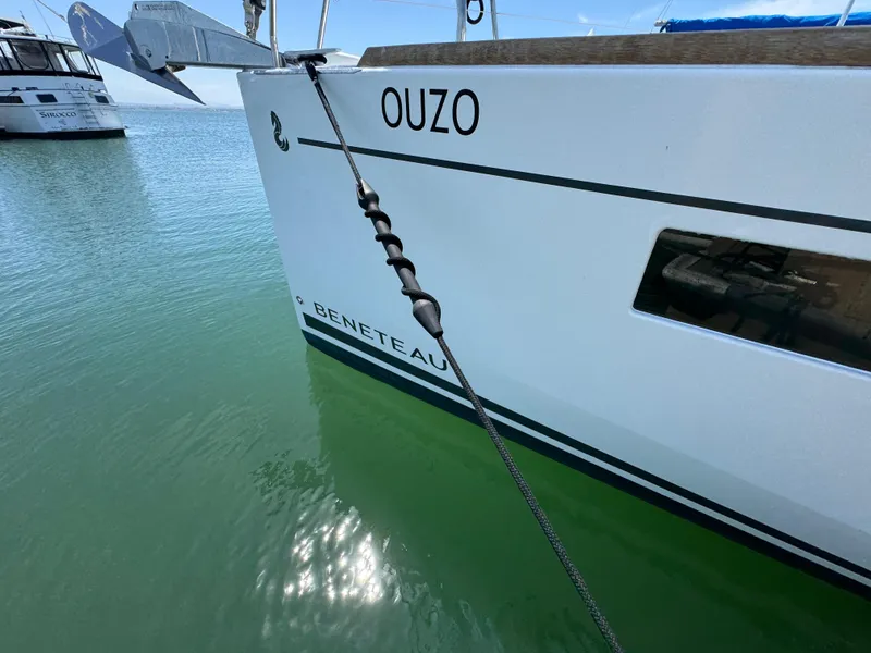 Slide: The Image of Beneteau Oceanis 35.1 sailboat docked, 2021 model, with visible anchor and water reflection. - 8
