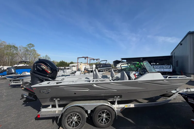 The Image of 2026 G3 Sportsman 2100 boat on trailer, parked outdoors under clear blue sky. - 0