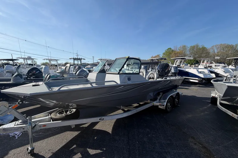 Slide: The Image of 2026 G3 Sportsman 2100 boat on trailer, displayed in a marina under clear blue sky. - 3