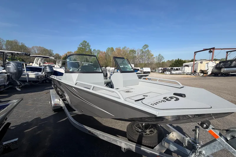 Slide: The Image of 2026 G3 Sportsman 2100 boat on trailer, parked outdoors under clear blue sky. - 4
