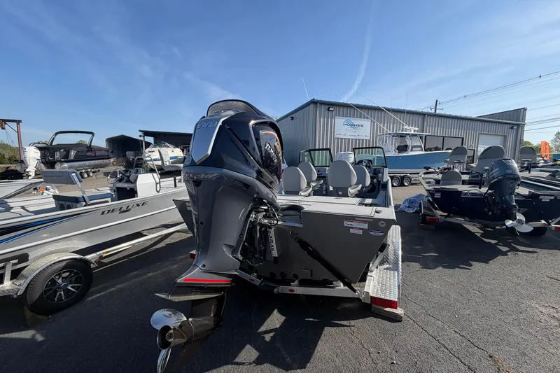 Slide: The Image of 2026 G3 Sportsman 2100 boat displayed outdoors at a dealership. - 5