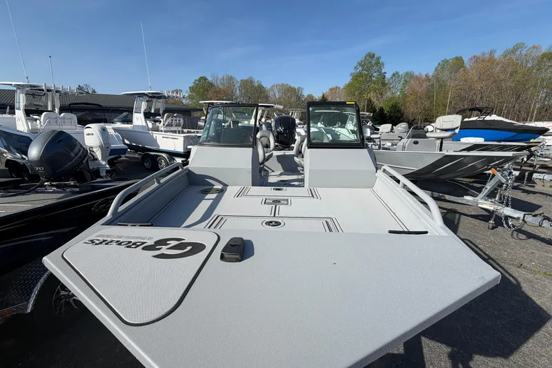 Slide: The Image of 2026 G3 Sportsman 2100 boat displayed in a marina with other vessels. - 6