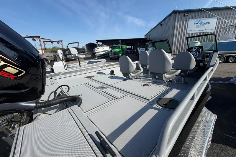 Slide: The Image of 2026 G3 Sportsman 2100 boat with spacious deck and seating, displayed outdoors. - 7