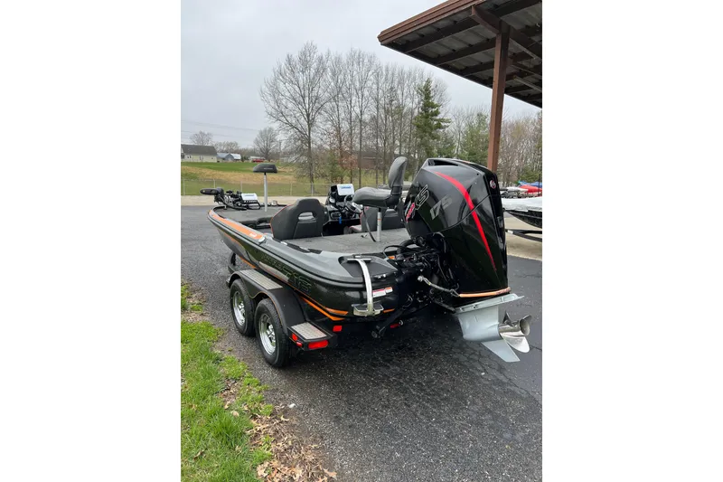 Slide: The Image of 2019 Nitro Z18 boat with powerful outboard motor, parked outdoors on a trailer. - 3