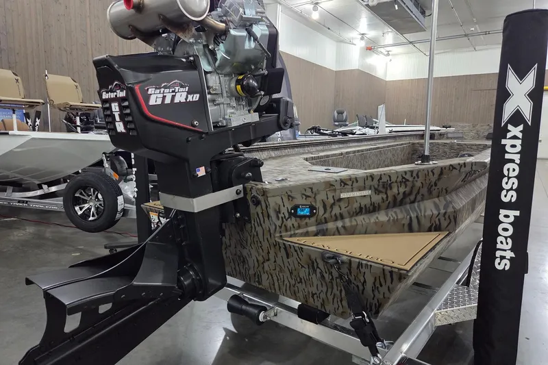Slide: The Image of 2026 Xpress Bayou 180 boat with Gator Tail GTR XD motor in showroom. - 6