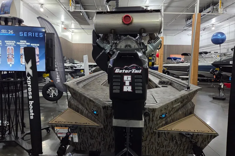 Slide: The Image of 2026 Xpress Bayou 180 boat with GatorTail motor displayed in showroom. - 7