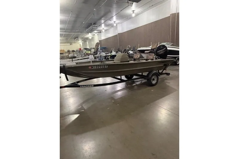 The Image of 2017 Tracker Grizzly 1754 MVX SC boat on trailer in indoor storage facility. - 0