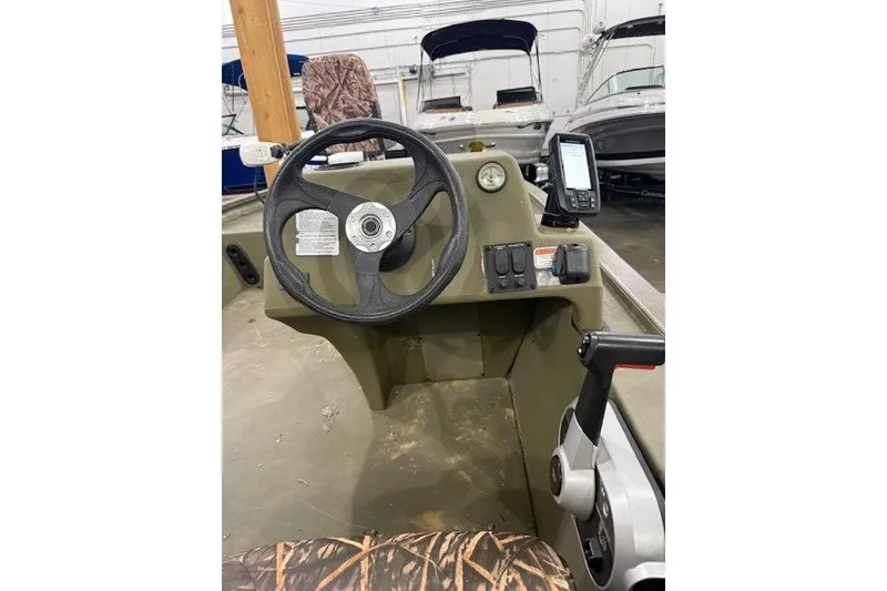 Slide: The Image of 2017 Tracker Grizzly 1754 MVX SC boat interior with steering wheel and control panel. - 3