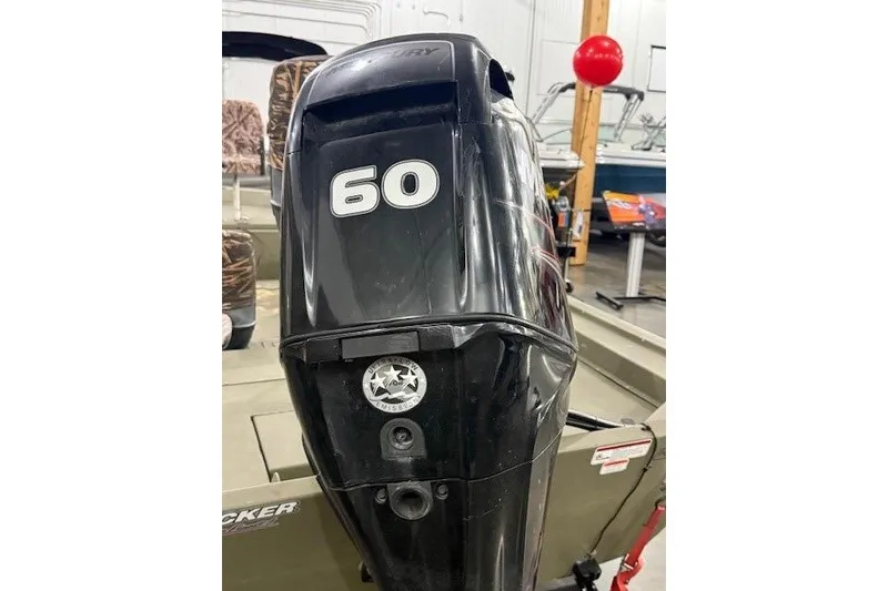 Slide: The Image of 2017 Tracker Grizzly 1754 MVX SC with 60 HP Mercury outboard motor in showroom. - 6