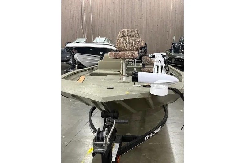 Slide: The Image of 2017 Tracker Grizzly 1754 MVX SC boat with camouflage seating in a showroom. - 9