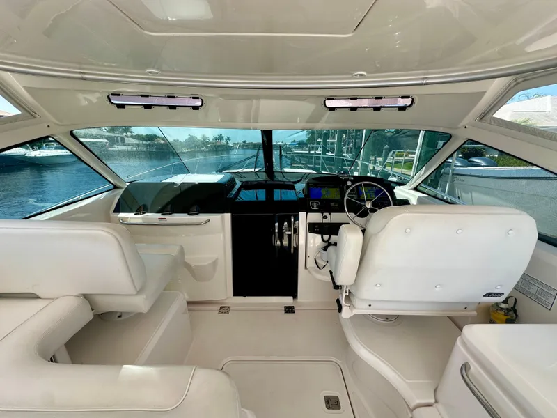Slide: The Image of 2018 Tiara Yachts 4300 Open helm with white seating and modern controls. - 15