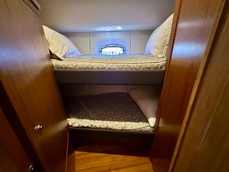 Slide: The Image of Bunk beds in 2018 Tiara Yachts 4300 Open cabin with wooden interior. - 31