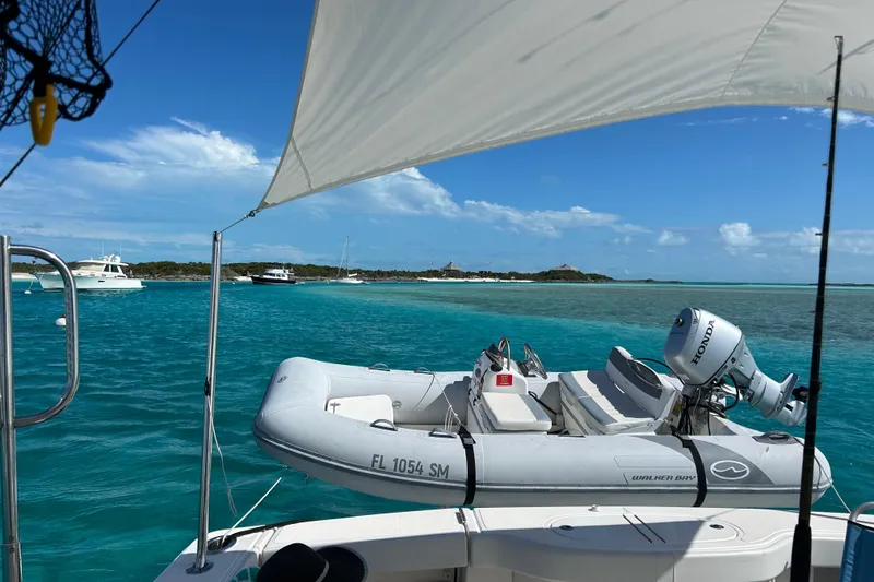 Slide: The Image of Tiara Yachts 4300 Open 2018 on turquoise waters with inflatable boat and clear skies. - 8