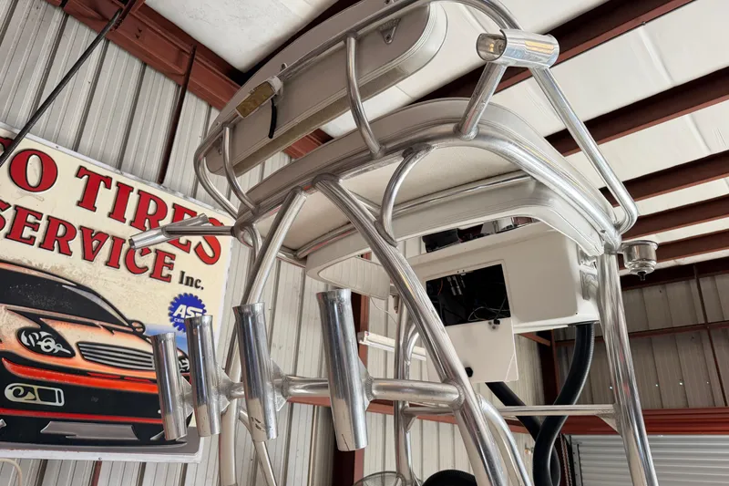 Slide: The Image of 2010 Canyon Bay 24H boat tower with rod holders in a garage setting. - 103
