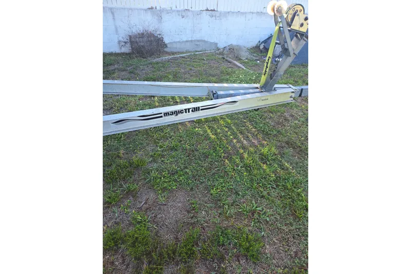 Slide: The Image of Trailer with "magic trail" branding on grassy area, part of a 2010 Canyon Bay 24H. - 104