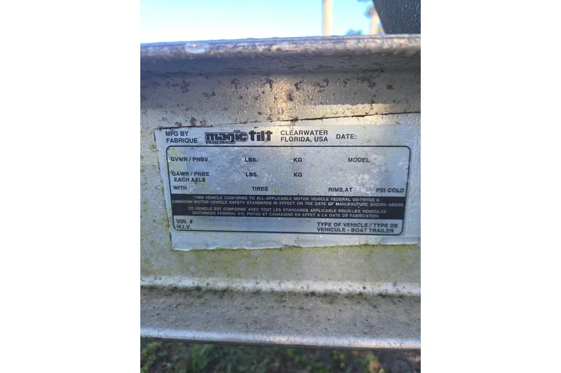 Slide: The Image of Magic Tilt boat trailer label, Clearwater, Florida, showing weight specifications and compliance details. - 105