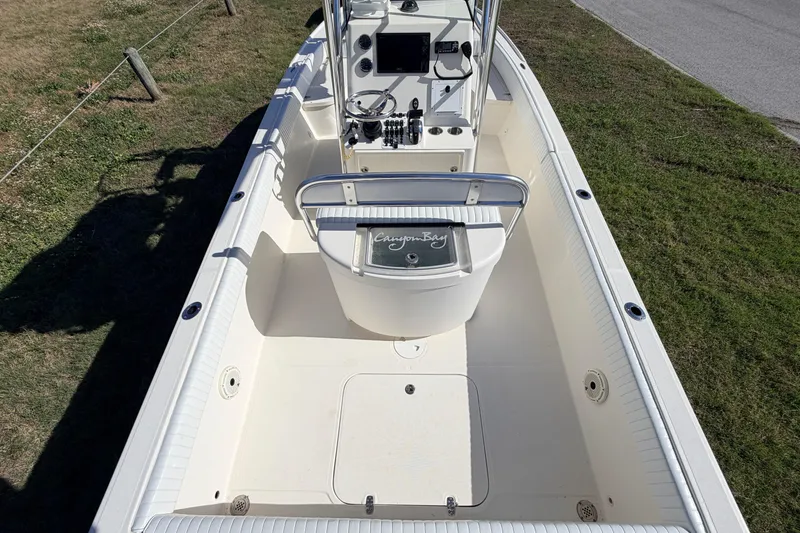 Slide: The Image of 2010 Canyon Bay 24H boat interior with console and seating, viewed from above. - 12