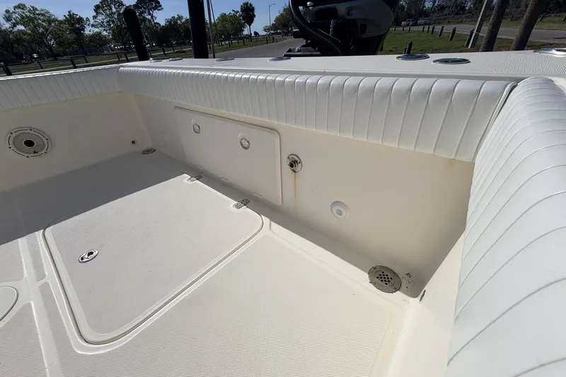 Slide: The Image of Interior view of a 2010 Canyon Bay 24H boat, showcasing seating and storage areas. - 17