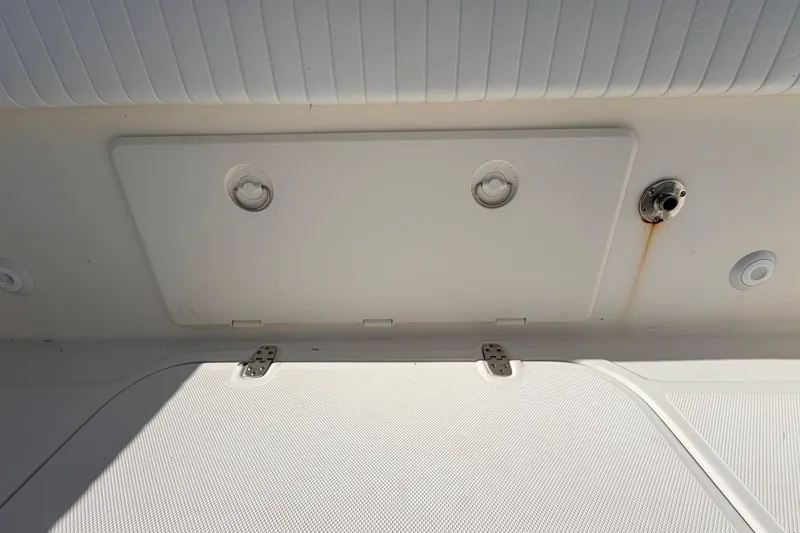 Slide: The Image of Canyon Bay 24H 2010 boat interior with storage compartment and fixtures. - 18