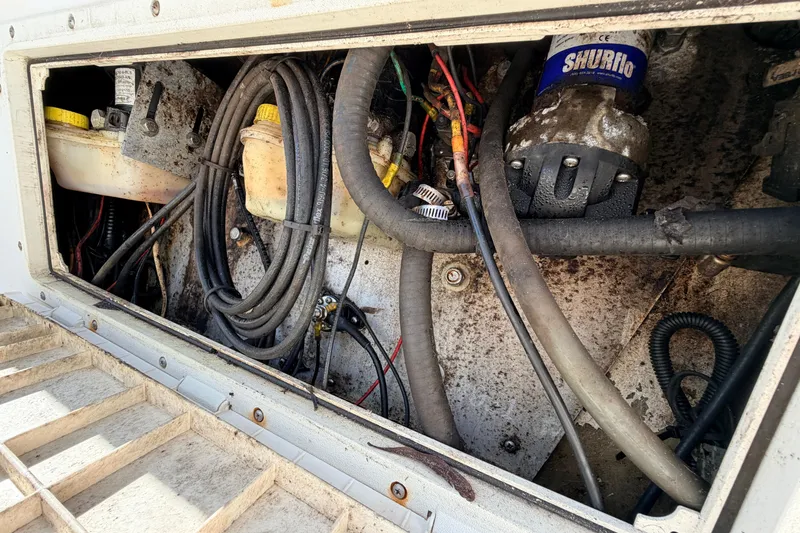 Slide: The Image of Engine compartment of a 2010 Canyon Bay 24H boat, showing cables and components. - 19