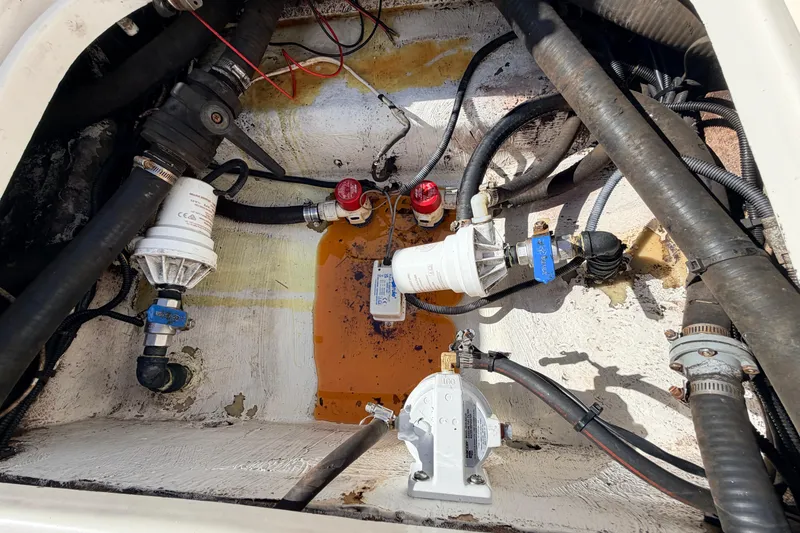 Slide: The Image of Engine compartment of a 2010 Canyon Bay 24H boat with visible hoses and filters. - 21