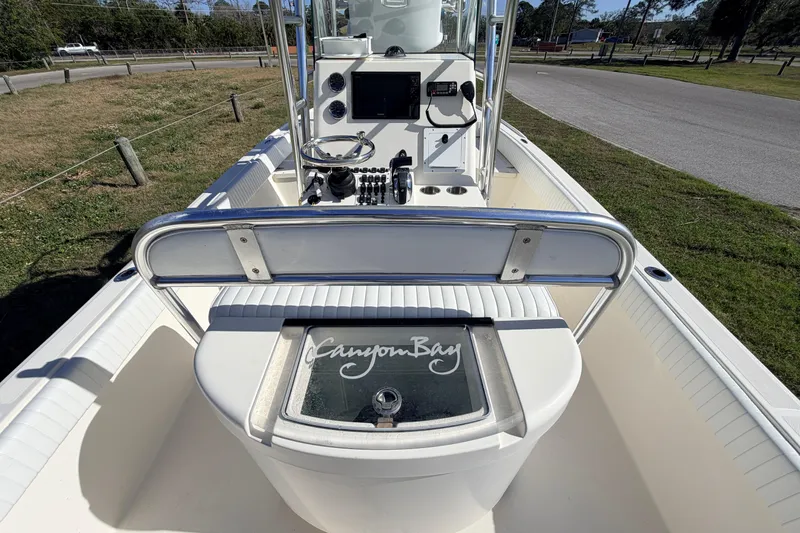 Slide: The Image of 2010 Canyon Bay 24H boat interior with steering console and seating area. - 22