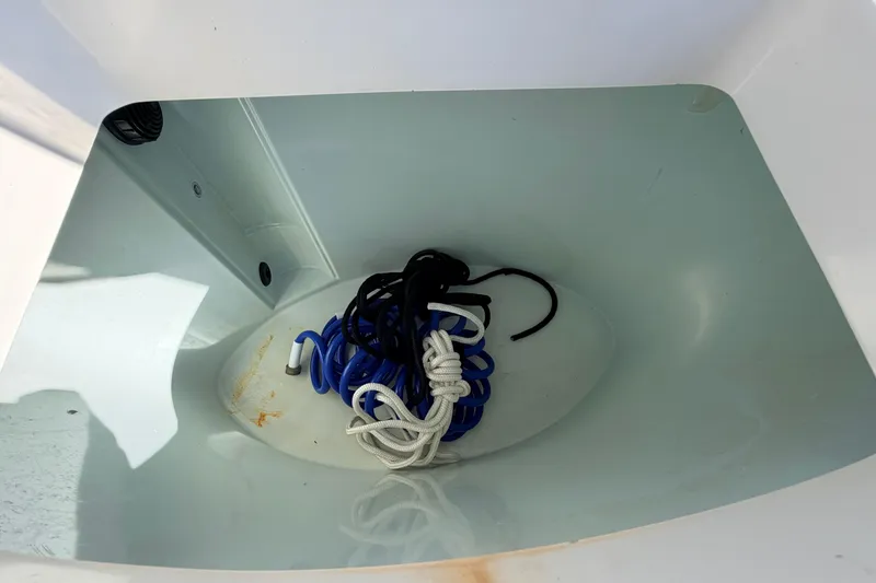 Slide: The Image of Storage compartment of a 2010 Canyon Bay 24H boat with coiled ropes. - 24