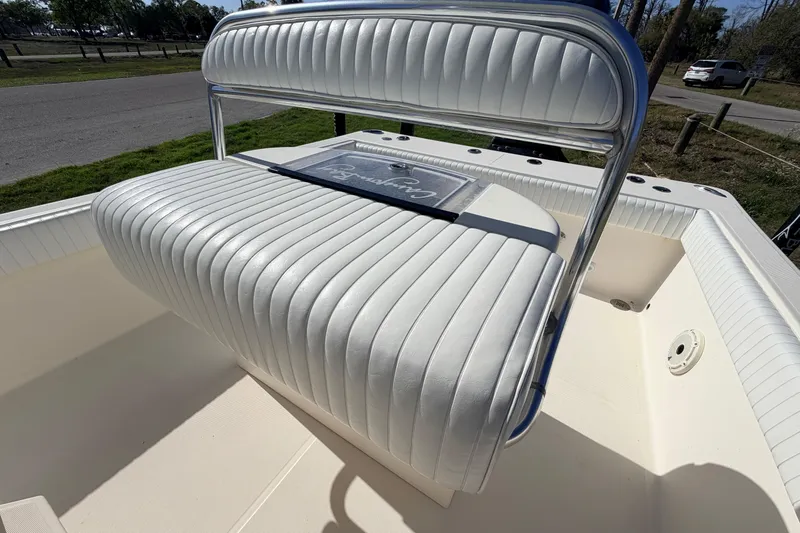 Slide: The Image of 2010 Canyon Bay 24H boat with white cushioned seating and chrome accents. - 25