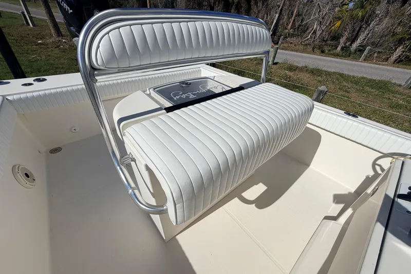 Slide: The Image of 2010 Canyon Bay 24H boat with white cushioned seating and sleek design. - 26