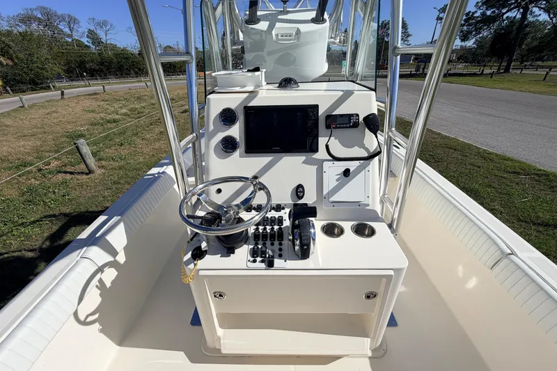 Slide: The Image of Center console of a 2010 Canyon Bay 24H boat with steering wheel and controls. - 27