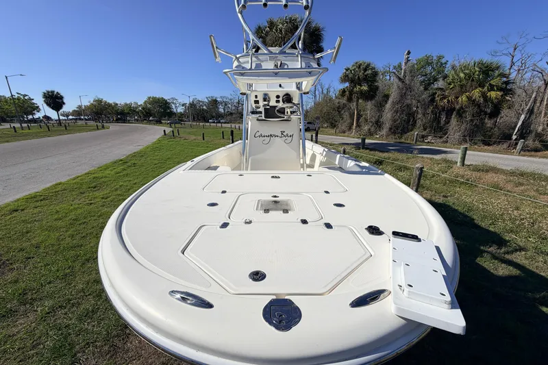 Slide: The Image of 2010 Canyon Bay 24H boat on grassy area with clear blue sky. - 29