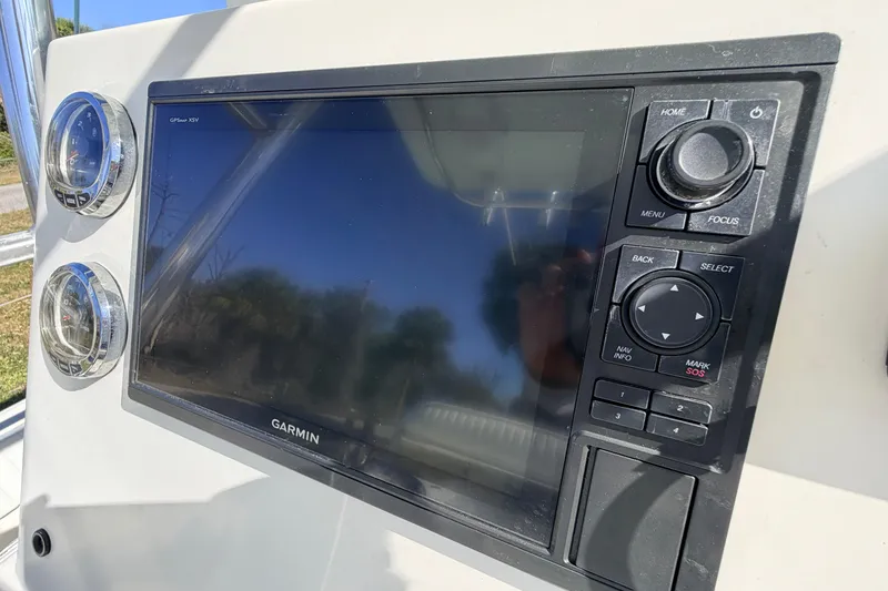 Slide: The Image of Garmin GPS display on 2010 Canyon Bay 24H boat dashboard with control buttons. - 30
