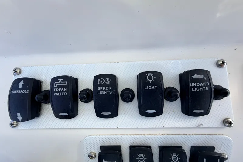 Slide: The Image of Control panel of a 2010 Canyon Bay 24H boat with various switches. - 36