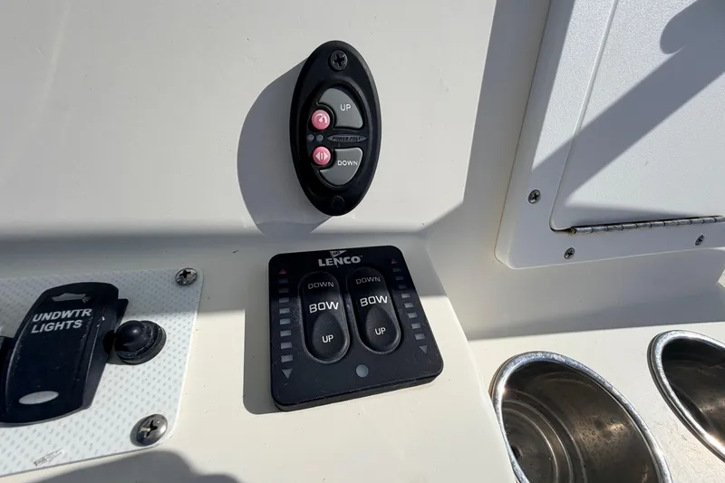 Slide: The Image of Control panel on a 2010 Canyon Bay 24H boat, featuring Lenco trim tab switches. - 37