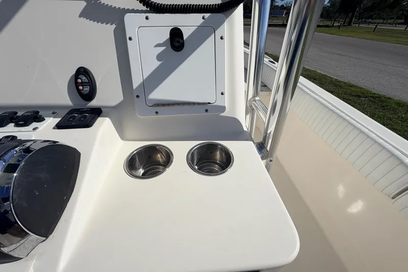 Slide: The Image of Canyon Bay 24H 2010 boat console with cup holders and control panel. - 38