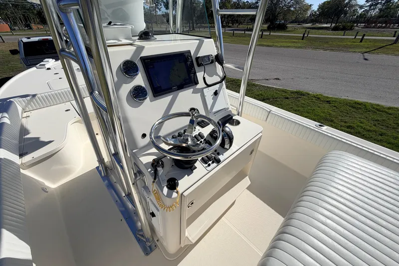 Slide: The Image of 2010 Canyon Bay 24H boat console with steering wheel and navigation display. - 41