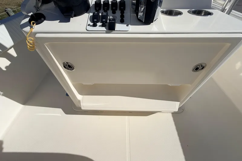 Slide: The Image of Canyon Bay 24H 2010 boat console with controls and cup holders in sunlight. - 42