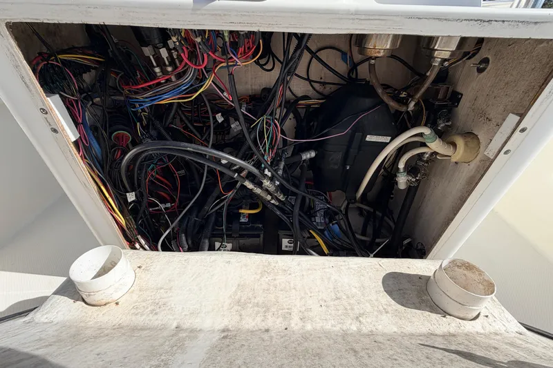 Slide: The Image of Electrical wiring and components inside a 2010 Canyon Bay 24H boat compartment. - 43