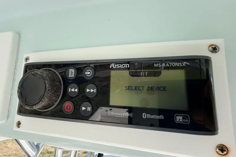 Slide: The Image of Fusion MS-RA70NSX stereo system on a 2010 Canyon Bay 24H boat, displaying "Select Device." - 50