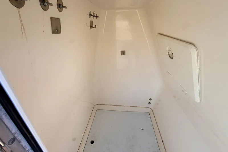 Slide: The Image of Interior of a 2010 Canyon Bay 24H boat compartment, featuring hooks and storage space. - 53