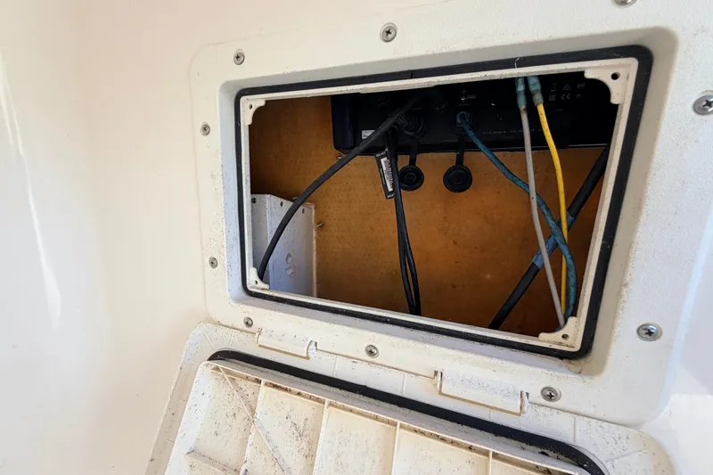 Slide: The Image of Open access panel with wiring inside a 2010 Canyon Bay 24H boat. - 54