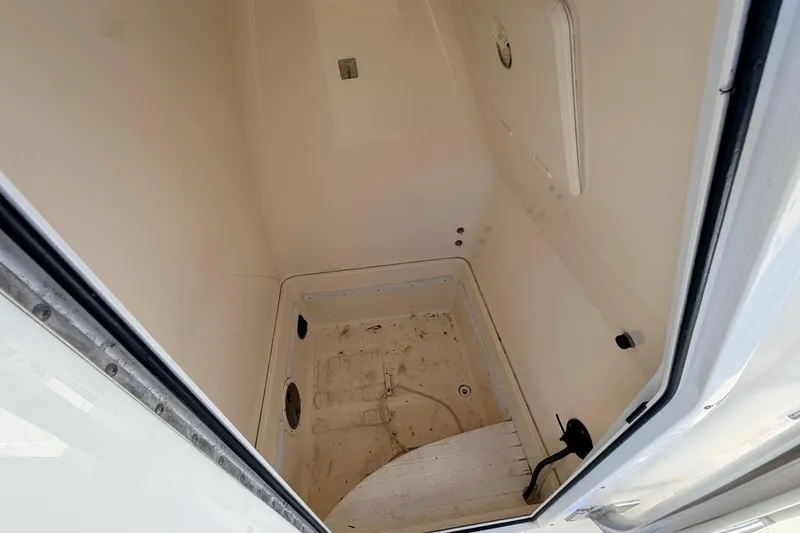 Slide: The Image of Interior view of a 2010 Canyon Bay 24H boat compartment, showing storage space. - 55
