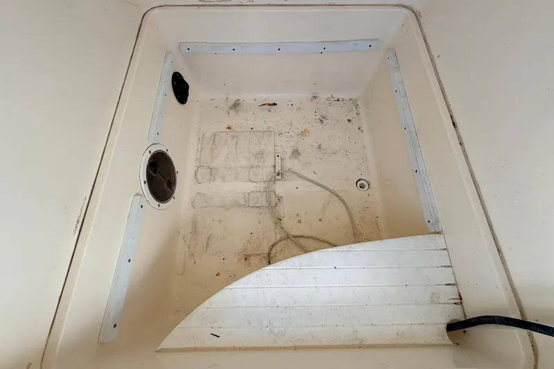 Slide: The Image of Empty storage compartment of a 2010 Canyon Bay 24H boat, showing interior details. - 56