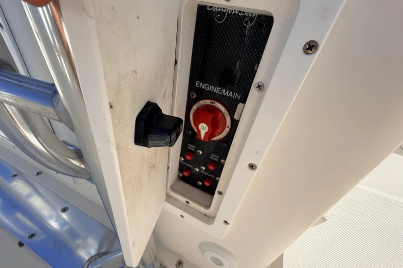 Slide: The Image of Control panel of a 2010 Canyon Bay 24H boat, featuring engine main switch. - 58