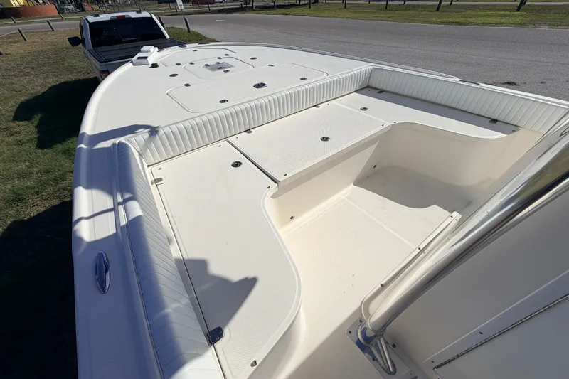 Slide: The Image of 2010 Canyon Bay 24H boat deck, spacious and clean, parked near a road. - 59