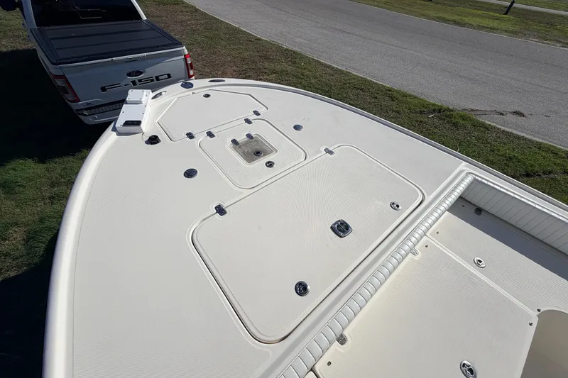Slide: The Image of 2010 Canyon Bay 24H boat on trailer, viewed from above, near a Ford F-150 truck. - 60