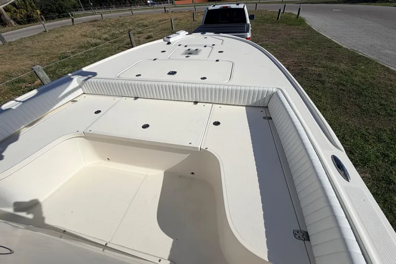 Slide: The Image of 2010 Canyon Bay 24H boat interior with white seating and storage compartments. - 61