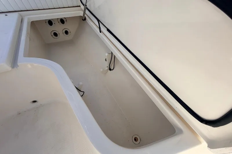 Slide: The Image of Open storage compartment on a 2010 Canyon Bay 24H boat, showcasing interior space. - 64