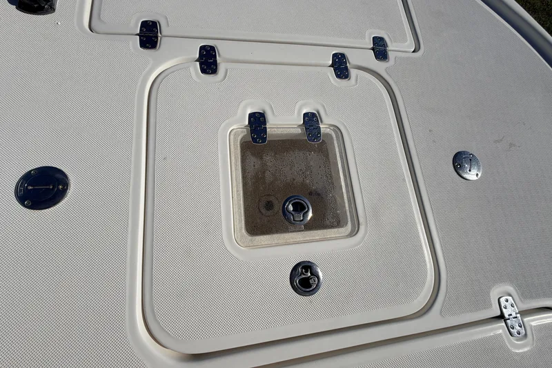 Slide: The Image of Canyon Bay 24H 2010 boat deck with storage compartments and metal fittings. - 72